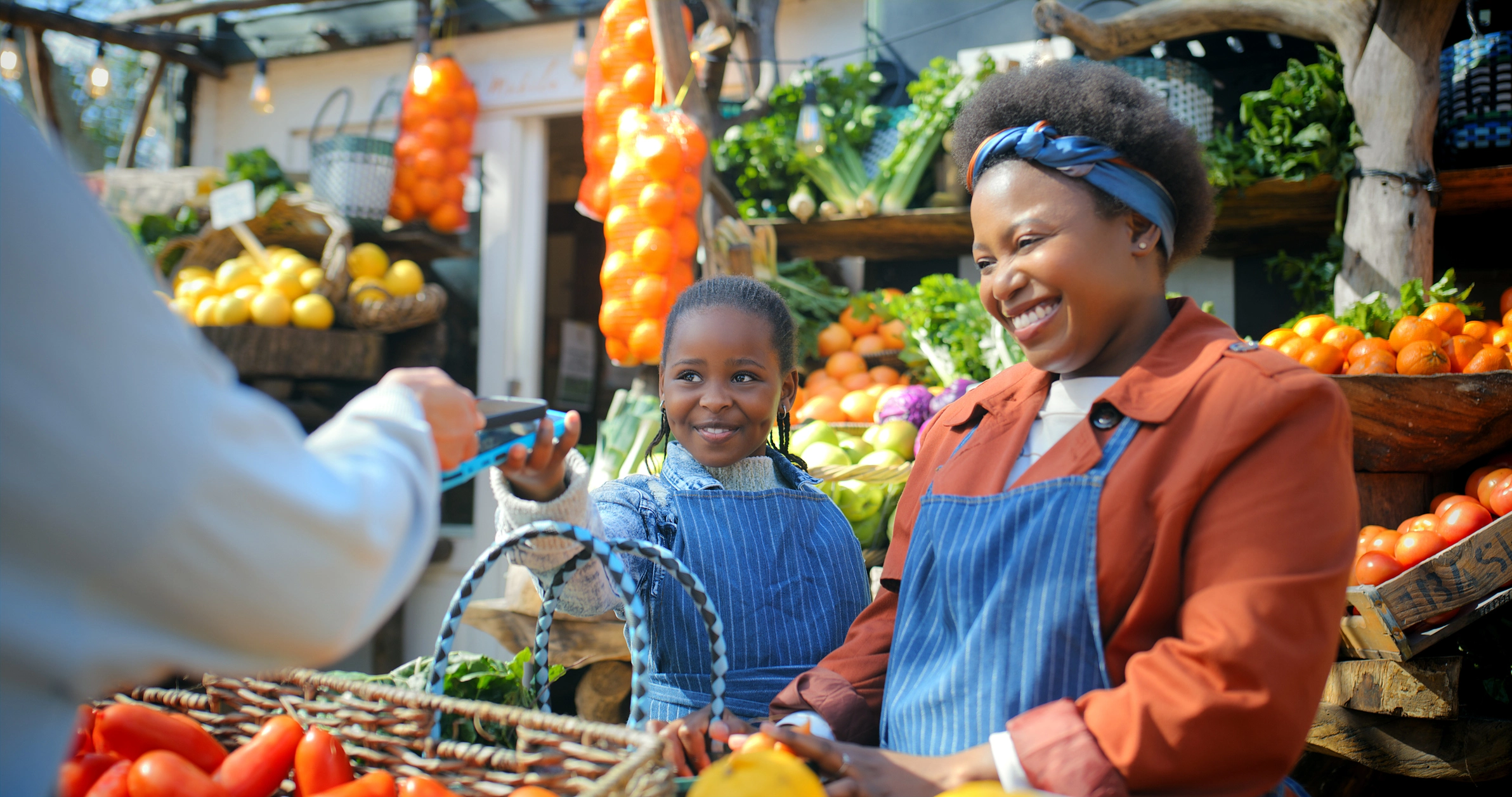 Mother and daughter vendor managing payments